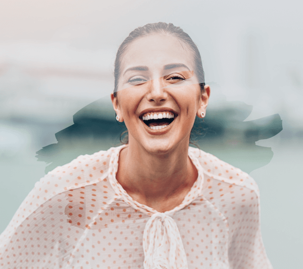 happy woman laughing with less opacity outside the Canva frame