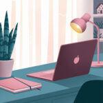 A desk with a pink laptop, lamp, and notebook. A potted plant sits nearby, creating a cozy workspace atmosphere.