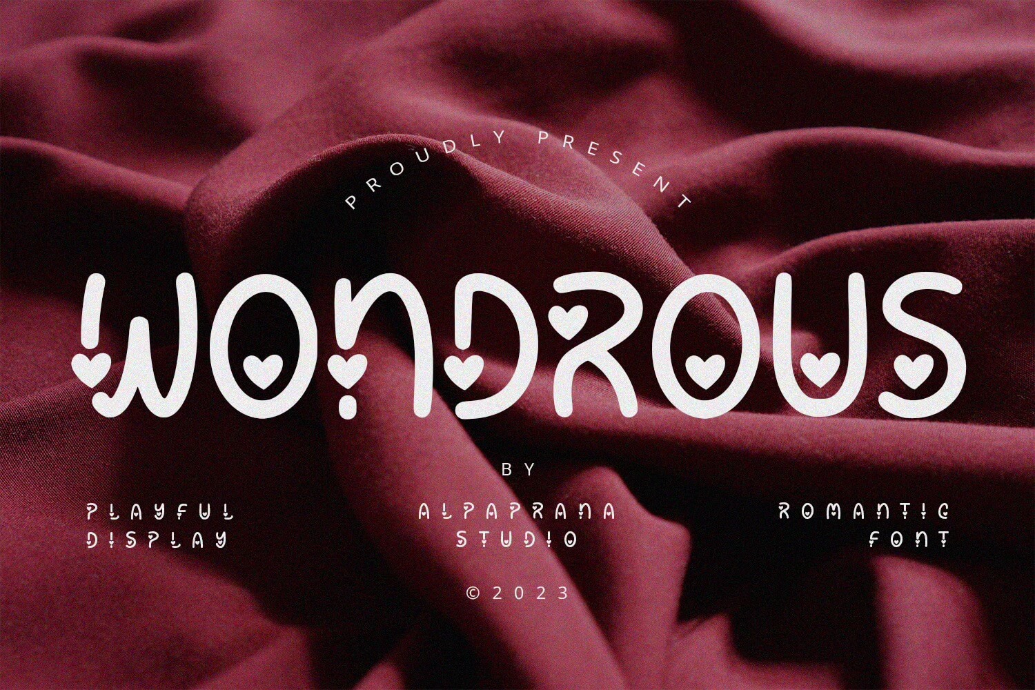 Playful display font "Wondrous" with heart details on burgundy fabric background, designed by Alpaprana Studio © 2023. Romantic and artistic style.