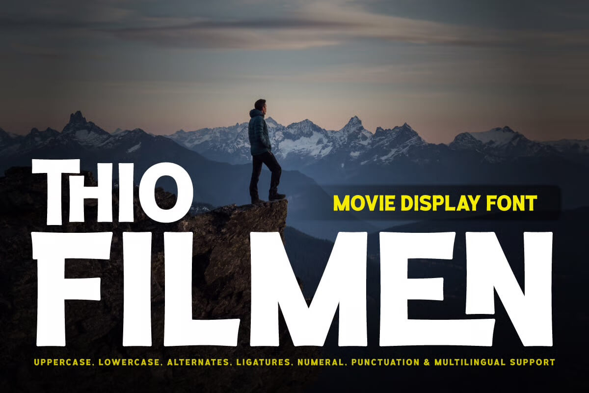 A person stands on a mountain cliff at sunset, gazing at snowy peaks. Bold typography overlays the scene promoting a movie display font.
